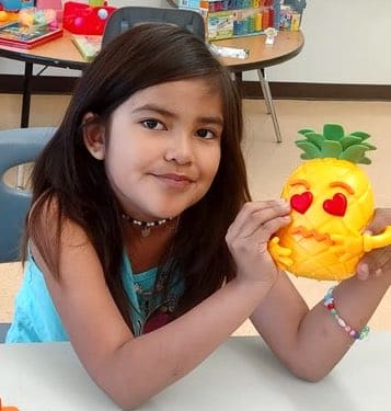 Young Girl displaying toy